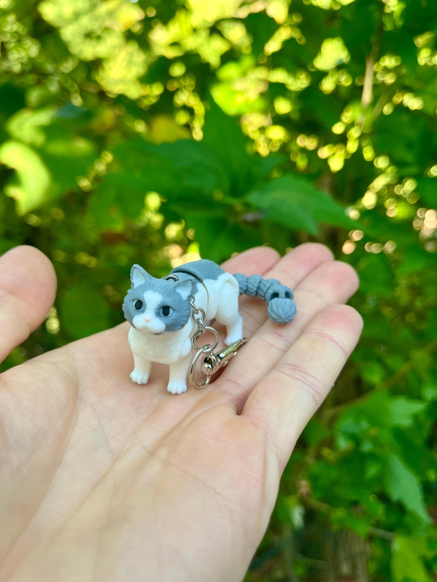Light grey articulated cat keychains