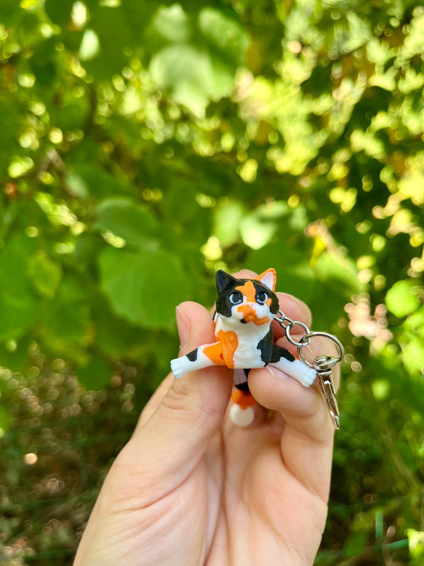Articulated calico cats keychains