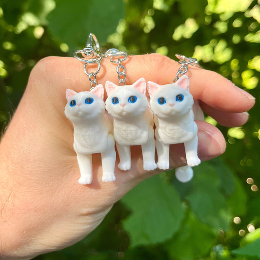 Articulated white cat keychain