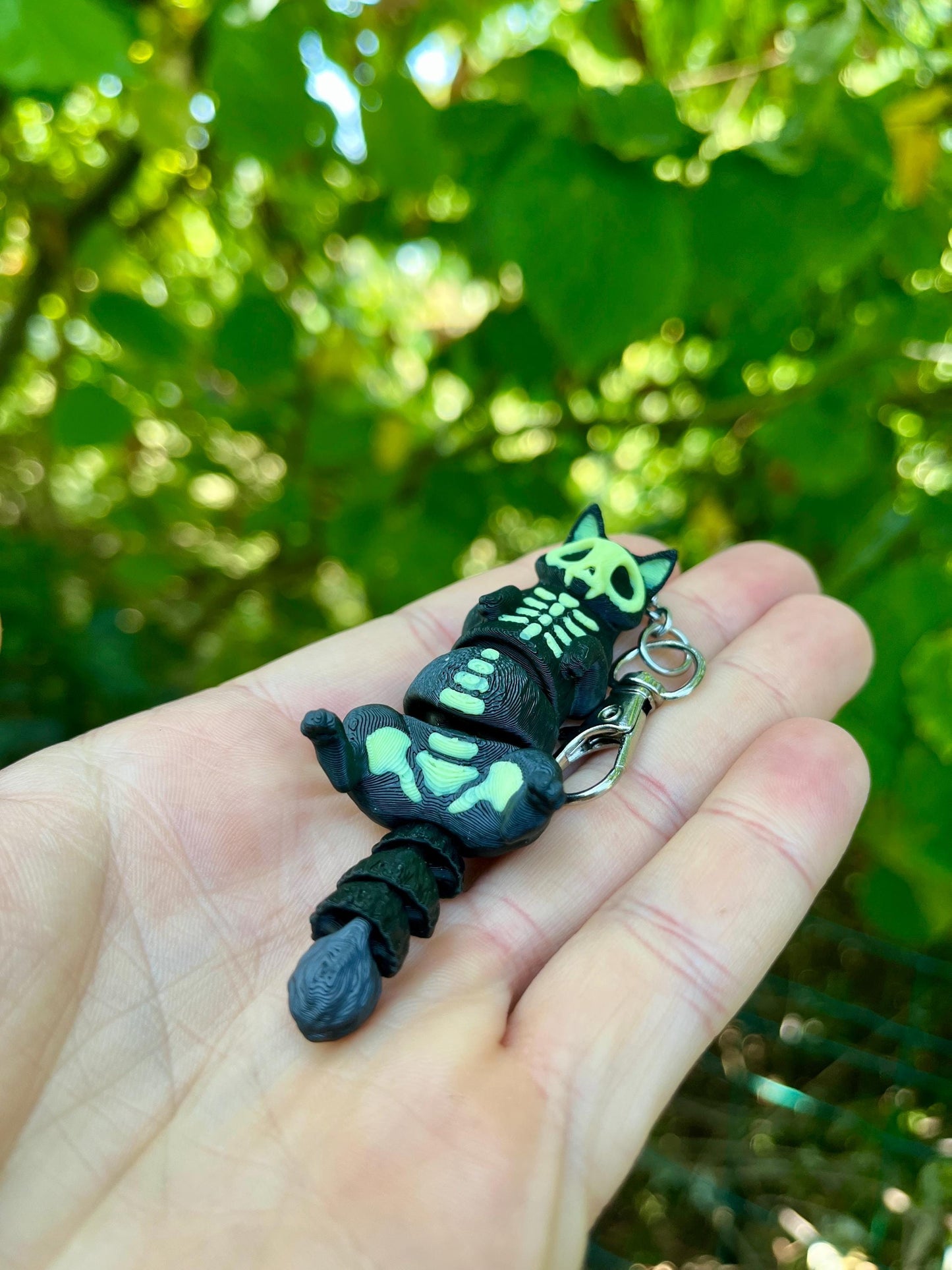 Glow-in-the-dark articulated skeleton cat keychain