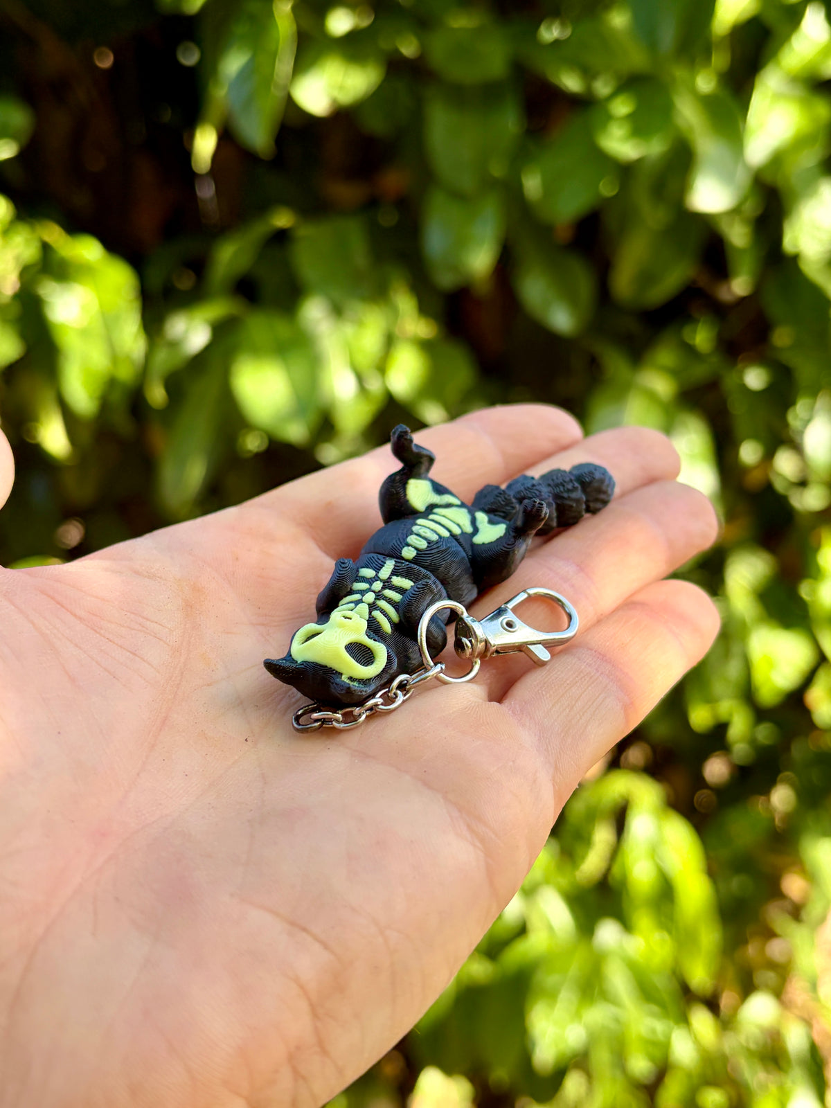 Glow-in-the-dark articulated skeleton cat keychain