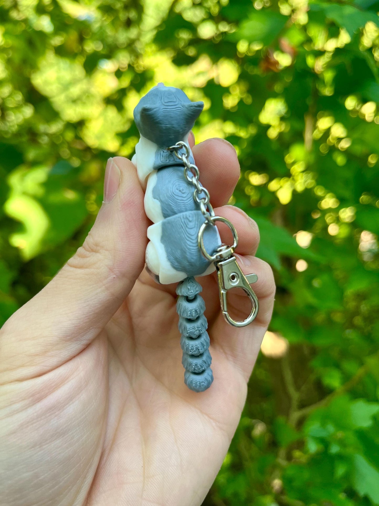 Light grey articulated cat keychains