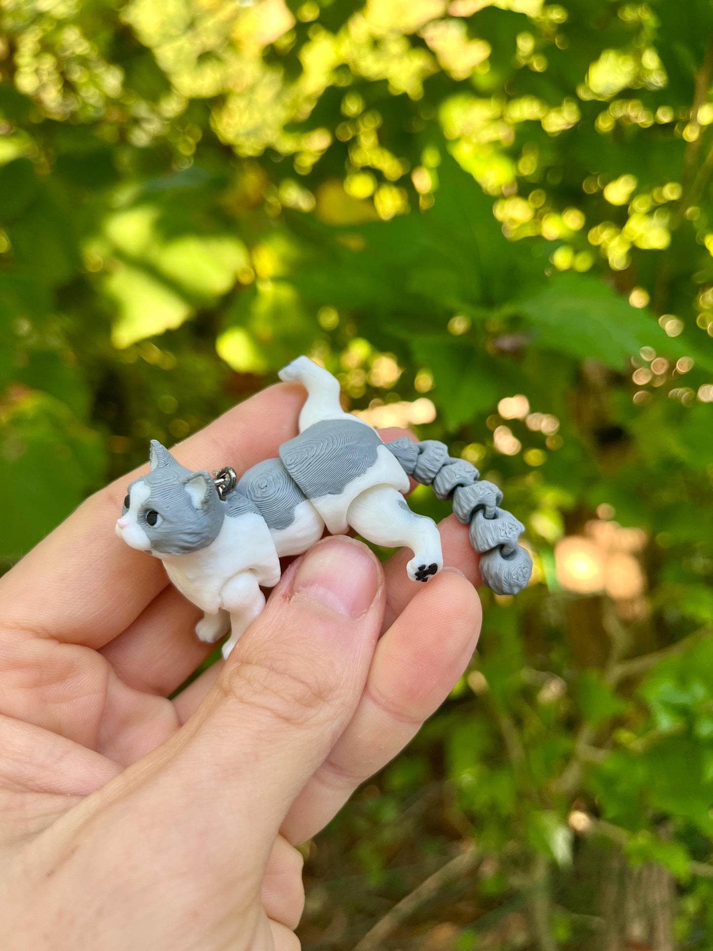 Light grey articulated cat keychains