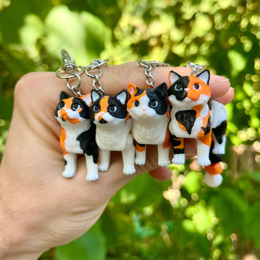 Articulated calico cats keychains