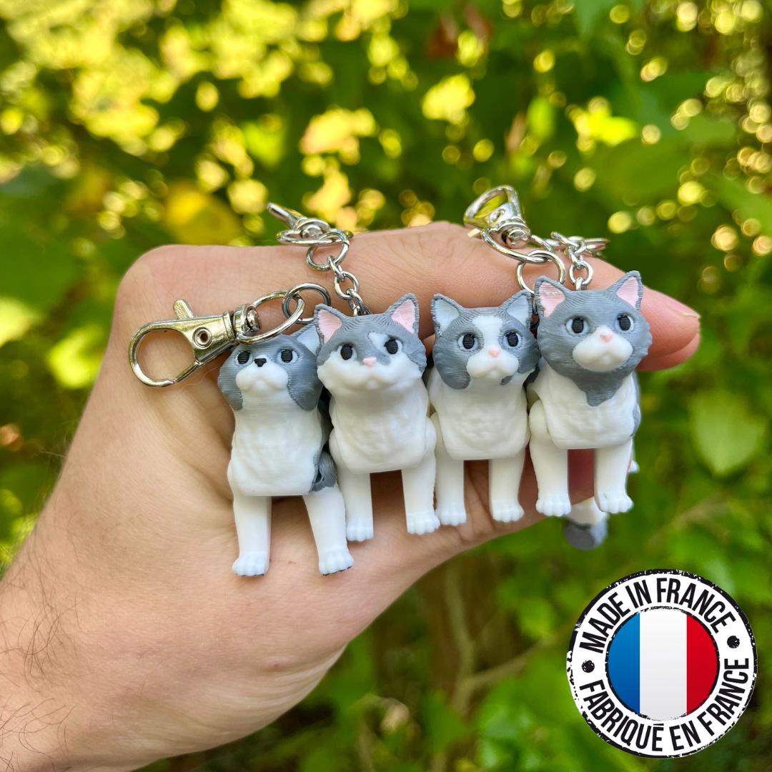 Light grey articulated cat keychains