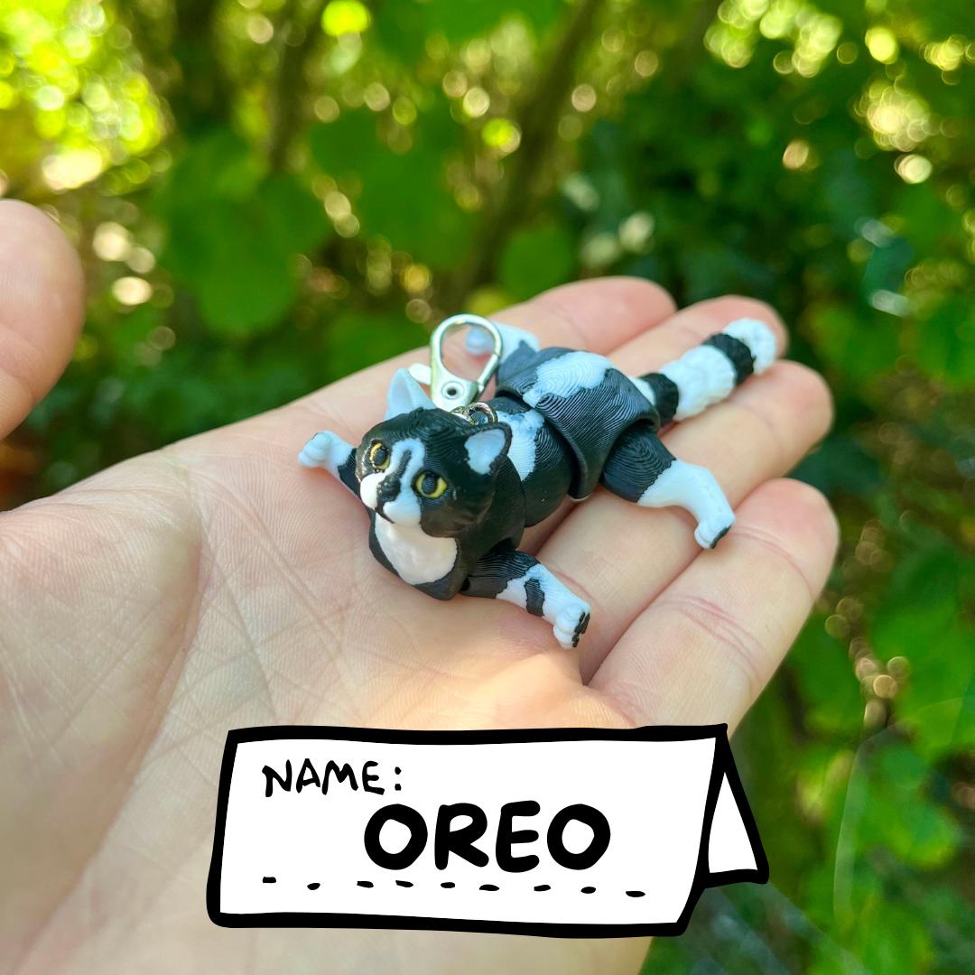 Articulated tuxedo cat keychains