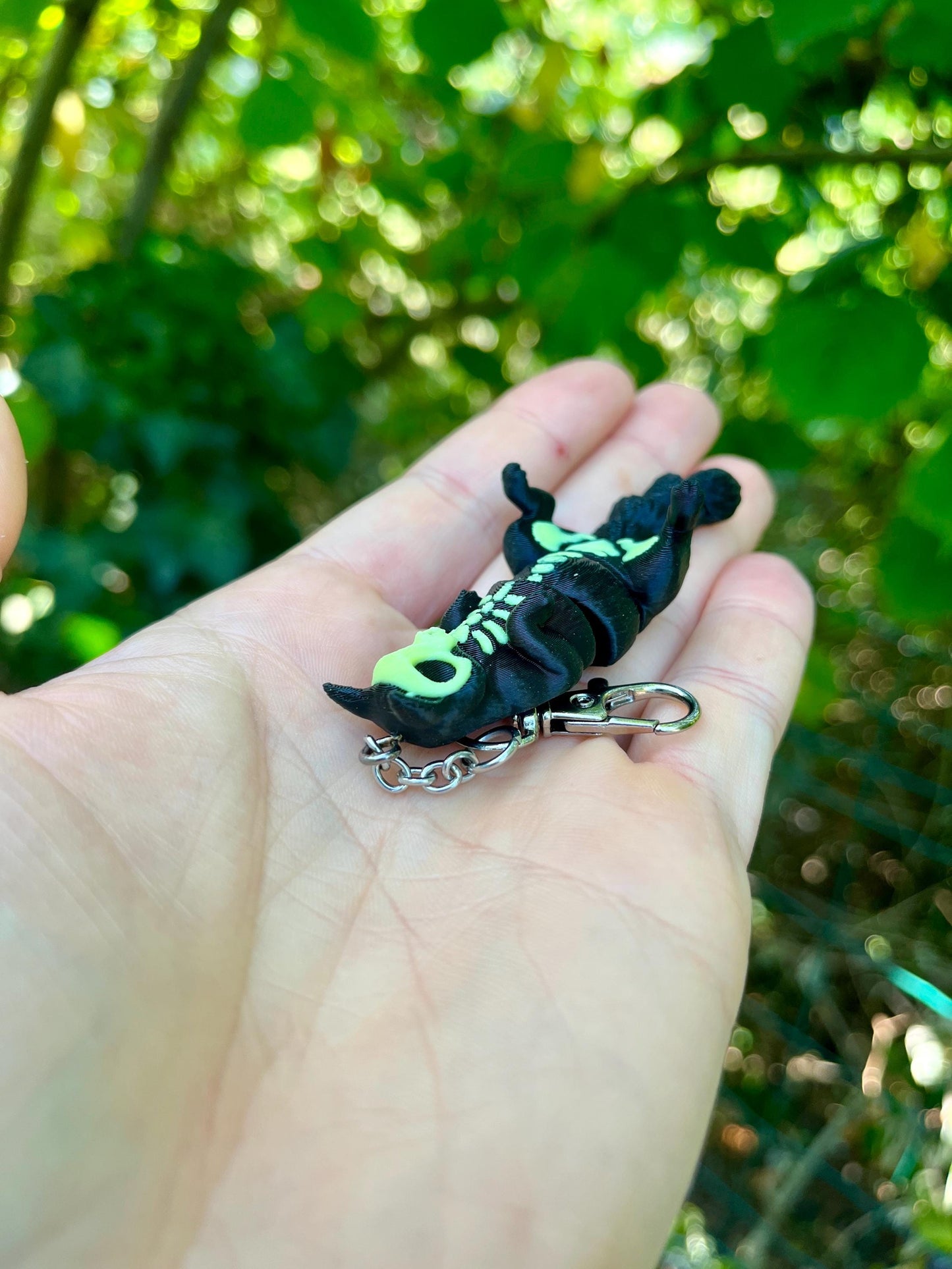 Glow-in-the-dark articulated skeleton cat keychain