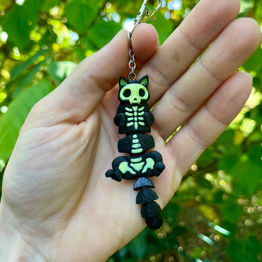 Glow-in-the-dark articulated skeleton cat keychain