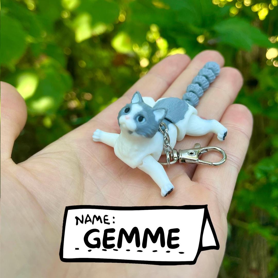 Light grey articulated cat keychains
