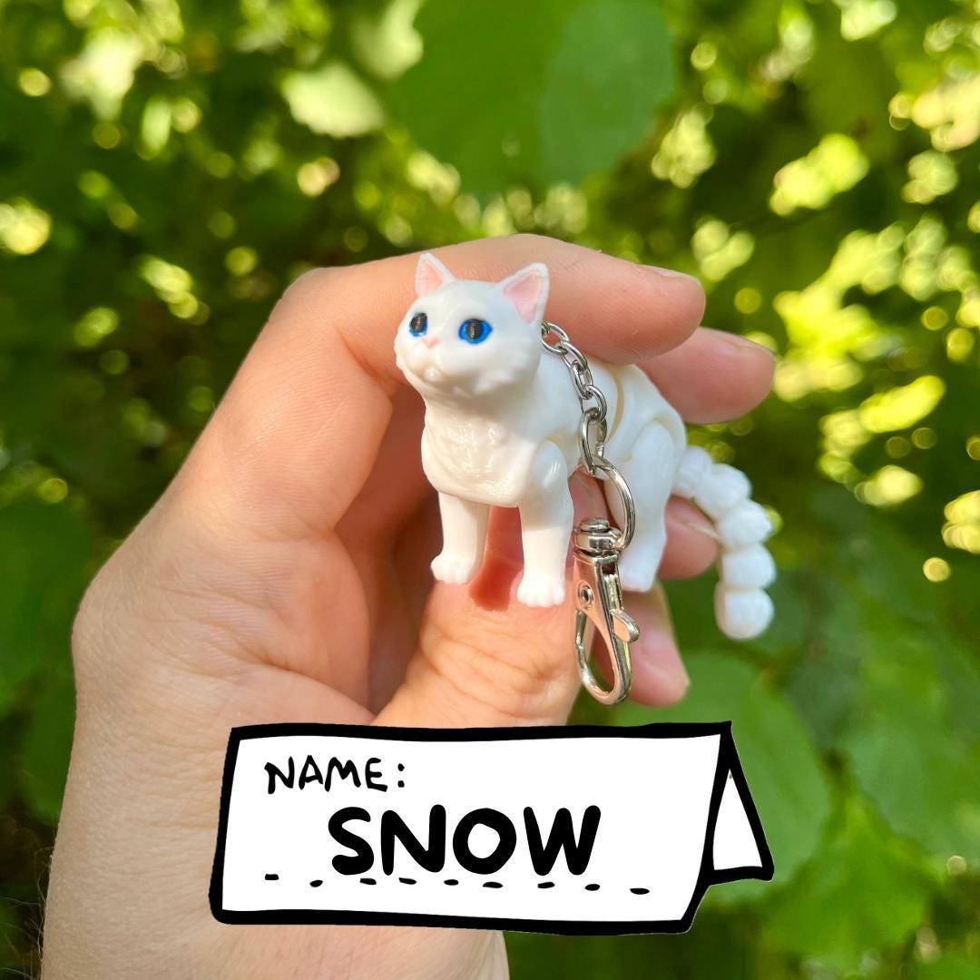Articulated white cat keychain