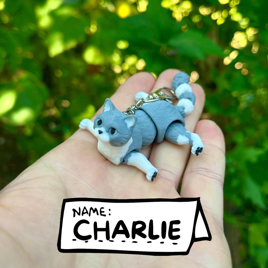 Light grey articulated cat keychains
