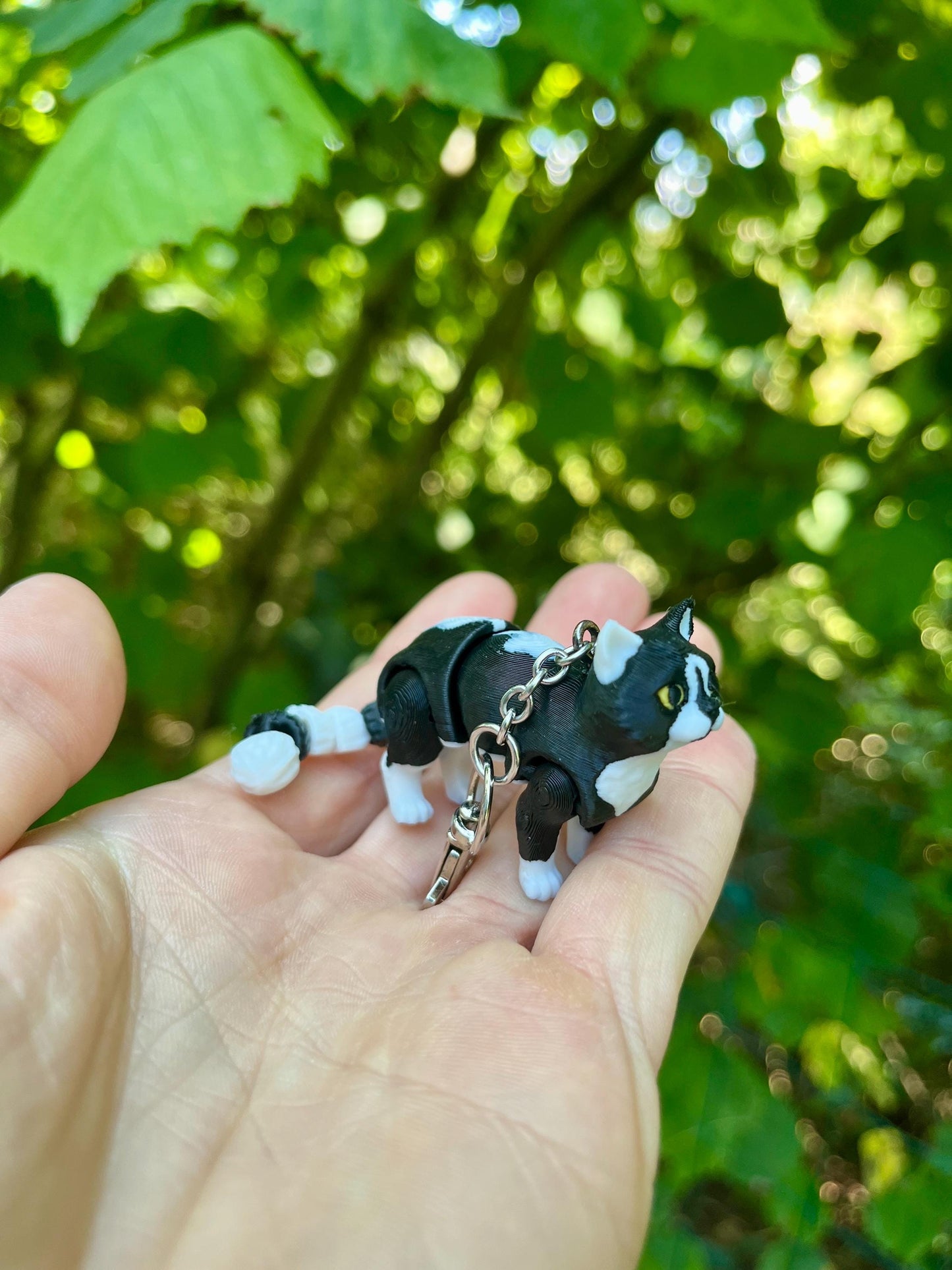 Articulated tuxedo cat keychains