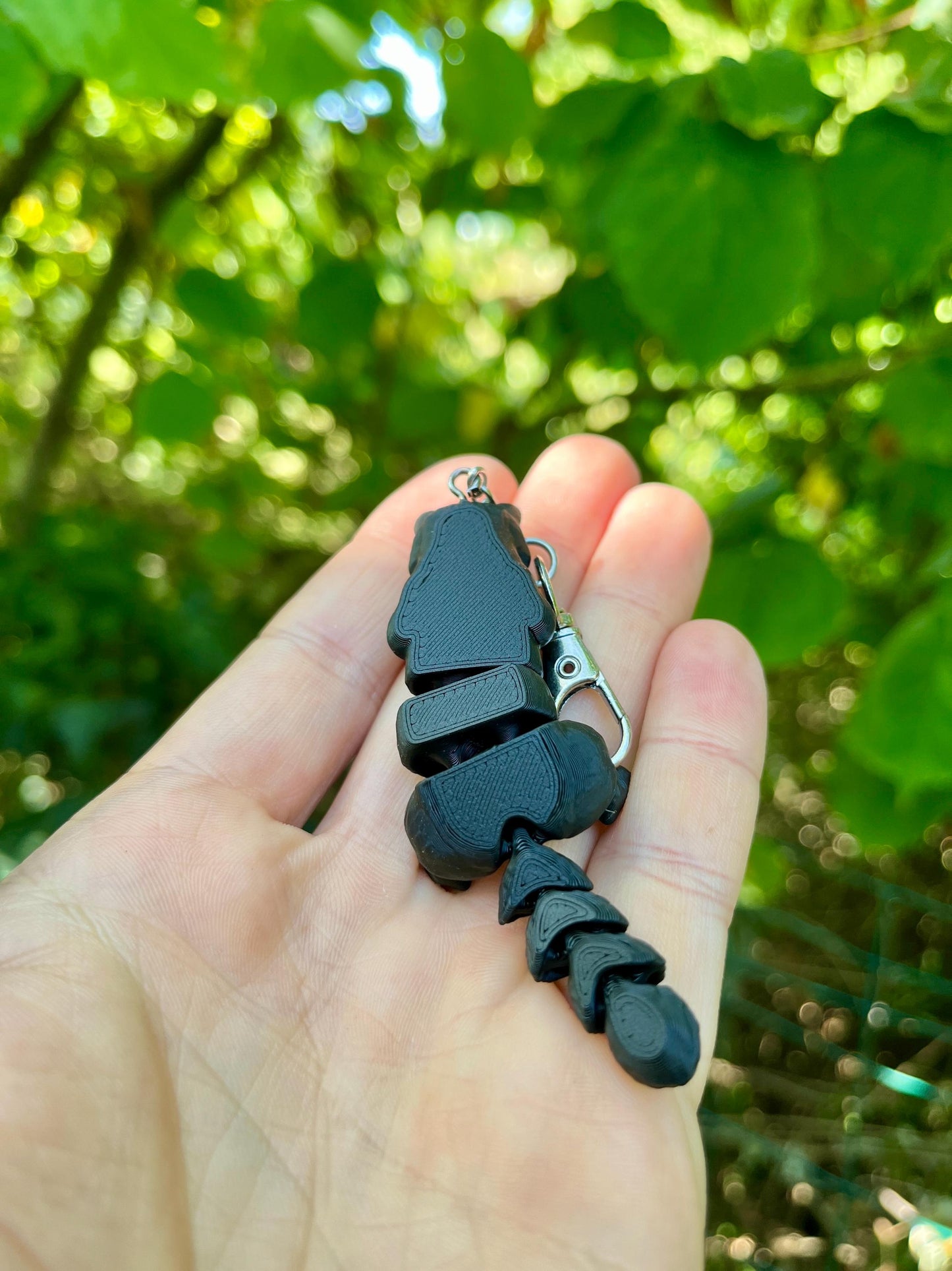 Glow-in-the-dark articulated skeleton cat keychain